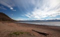 Driftwood log on beach at the head of the Kachemak bay near Homer Alaska USA Royalty Free Stock Photo