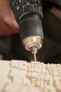 Drill Bit Perforating Hole on Plaster Model Royalty Free Stock Photo