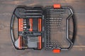 Drill bit set organized in a plastic case on wooden surface. Royalty Free Stock Photo