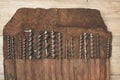 Drill bits in leather tool roll on a wooden workbench Royalty Free Stock Photo