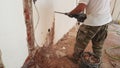 Drill concrete construction in an old room worker hands