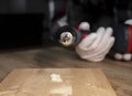 Drill tool closeup over hole in wood surface, close up