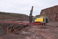 Driller in a quarry mine. porphyry rocks.