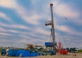 Drilling rig for drilling oil and gas wells on the background of a beautiful sky. Royalty Free Stock Photo