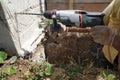 Drilling a hole in the concrete wall with a jackhammer, perforator in operation Royalty Free Stock Photo