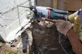 Drilling a hole in the concrete wall with a jackhammer, perforator in operation Royalty Free Stock Photo