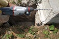 Drilling a hole in the concrete wall with a jackhammer, perforator in operation Royalty Free Stock Photo