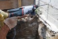 Drilling a hole in the concrete wall with a jackhammer, perforator in operation Royalty Free Stock Photo