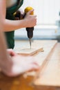 Drilling a hole in a wooden board on the workbench Royalty Free Stock Photo
