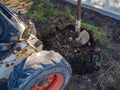 Drilling holes in the ground with a tractor with auger drill