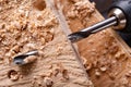 Drilling holes in raw wood. Carpentry drill in a carpentry workshop