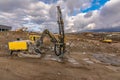 Drilling machine and excavators in a workplace