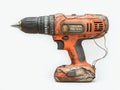 Drilling machine with power cord in a workshop setting on a workbench with tools and materials around it