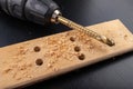 Drilling in a piece of dry planed wood. Holes made in the workshop with a screwdriver Royalty Free Stock Photo