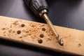 Drilling in a piece of dry planed wood. Holes made in the workshop with a screwdriver Royalty Free Stock Photo