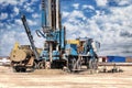 Drilling rig in a field under a blue cloudy sky. Drilling deep wells. Geological exploration. Mineral exploration
