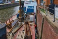 Drilling ship with erected drilling tower for drilling the foundation soil at the quay wall in the harbour