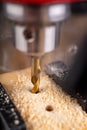 Drilling in wood with professional tools. Work on a bench drill Royalty Free Stock Photo