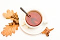 Drink and acorn and oak leaves. Tea served with spoon, sugar and decor as cinnamon. Mug filled with black brewed tea Royalty Free Stock Photo