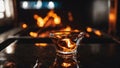 drink in the bar A cozy lover enjoying a drink by the fire in a black countertop with a glass of amber liquid on fire Royalty Free Stock Photo