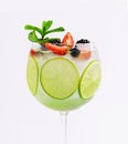 Drink with berries, with lime slices and mint in a wine glass Royalty Free Stock Photo
