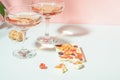 Drink champagne or wine in two elegant glasses and a bar of white chocolate. Gentle pink background bright sunlight. Royalty Free Stock Photo