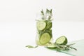 Drink of chopped cucumber and rosemary on white background Royalty Free Stock Photo