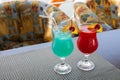 drink cocktail alcohol turquoise blue hawaii and sex on the beach with cherry decoration in a restaurant Royalty Free Stock Photo