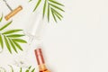 Empty wine glass, bottle of rose wine and palm leaves on a white background Royalty Free Stock Photo