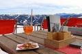 Drink and cookies on the table in the mountains. Menu and cutlery.