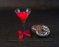 Drink cosmopolitan a glass of martini decorated with a red bow w