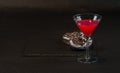 Drink cosmopolitan a glass of martini decorated with two oreo do