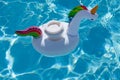 Drink cup in inflatable unicorn toy in swimming pool Royalty Free Stock Photo