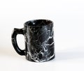 Drink cup made of natural black obsidian. Isolated on a white background Royalty Free Stock Photo