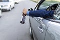 drink and drive. man drinks off a bottle of beer while driving car. concept of alcohol, dangerous driving. driver throws Royalty Free Stock Photo