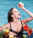 Drink fresh summer Cocktail with fruit at sexy girl in pool on Maldives. Summer vacation and swimming at sea. Pool party Royalty Free Stock Photo