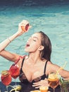 Drink fresh vitamin juice, diet. Cocktail with fruit at sexy girl in pool on maldives. Summer vacation and swimming at Royalty Free Stock Photo