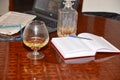 Drink a glass cognac and bottle alchool work business notebook newspaper glasses hobbies