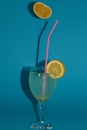 drink glass lemonade beautifully arranged and above it a lemon from which a few drops in a glass leak Royalty Free Stock Photo