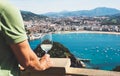 Drink glass white wine in male hands holidays looks top view city coast yacht from observation deck, romantic tourist man toast wi Royalty Free Stock Photo