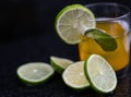 Drink, juice in a glass with a lemon slice, mint and cut lemons around Royalty Free Stock Photo
