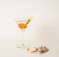 Drink in martini glass, martini drink with green olives, seashells Royalty Free Stock Photo