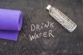 Drink more water - hydration reminder - handwriting on On a chalk board Royalty Free Stock Photo