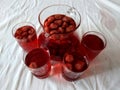 drink with natural berries of strawberry, bright red color, tasty, it is useful, vitamins it is poured in a glassand glasses