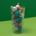 Drink from New Year`s decorations on a background of green shades. Minimalistic scene