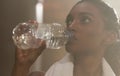 Drink plenty of fluids to keep yourself fuelled. a sporty young woman drinking water in a gym. Royalty Free Stock Photo