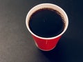 Drink in a red paper cup on a dark background Royalty Free Stock Photo