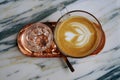 Drink scene of Hot Latt Coffee in yellow Cup on Brown wood Table at Coffee Cafe in Danang Vietnam