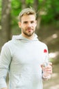 Drink some water. Man handsome jogger holds water bottle whole workout in park. Man athlete sport clothes refreshing Royalty Free Stock Photo