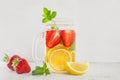 Drink with strawberry lemon and mint on white